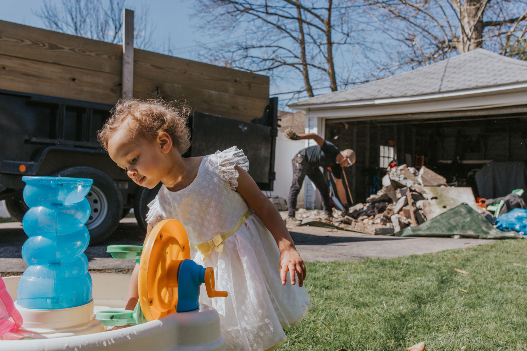 My husband, Greg, took on the herculean task of tearing up a concrete slab in our backyard and turning it into a usable play space for our daughter.